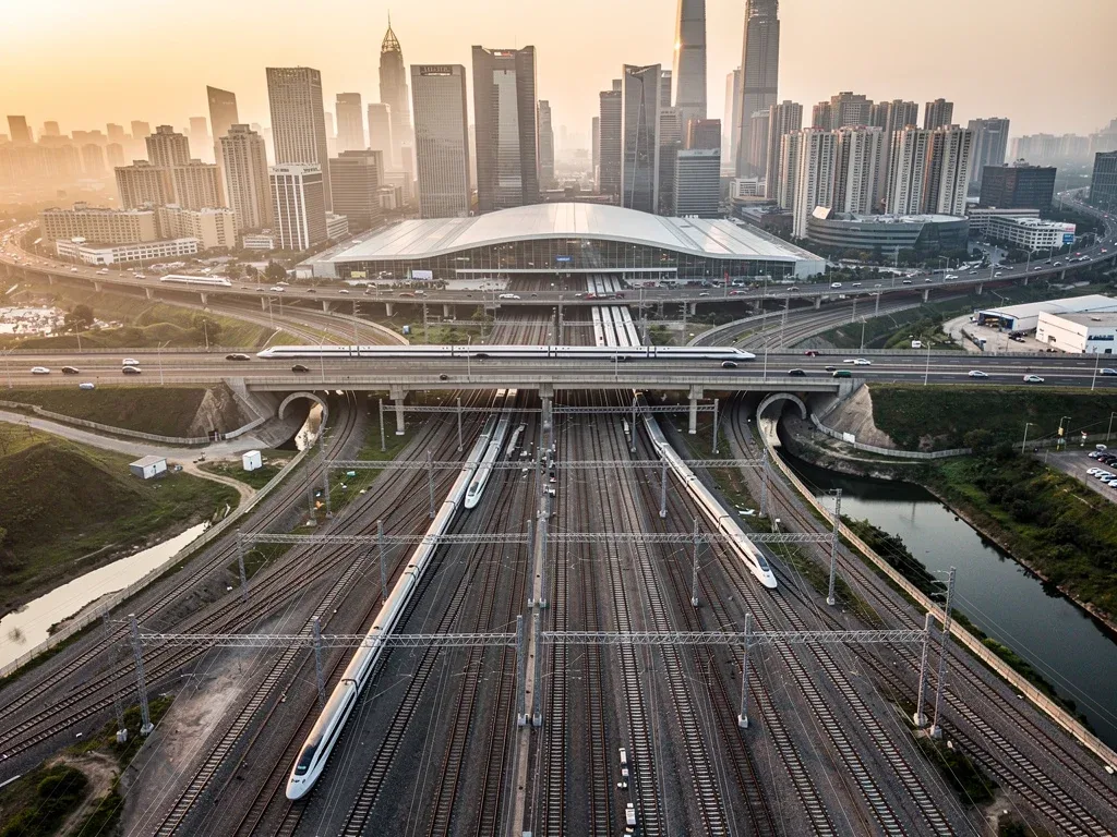 Intricate railway network leading to a bustling city, representing major transportation corridors.